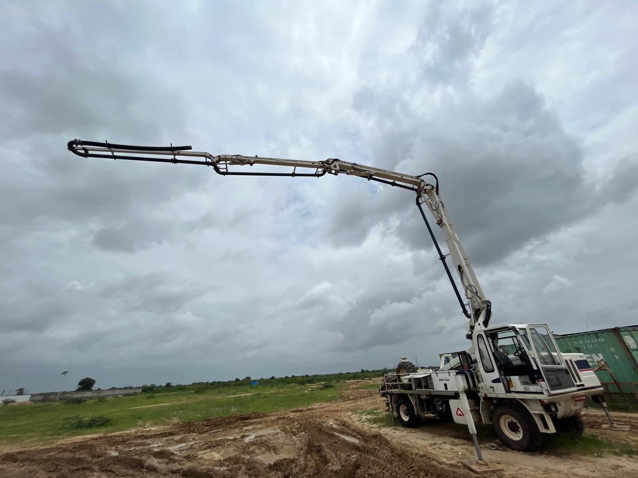 Concrete boom pump positioned at a construction site